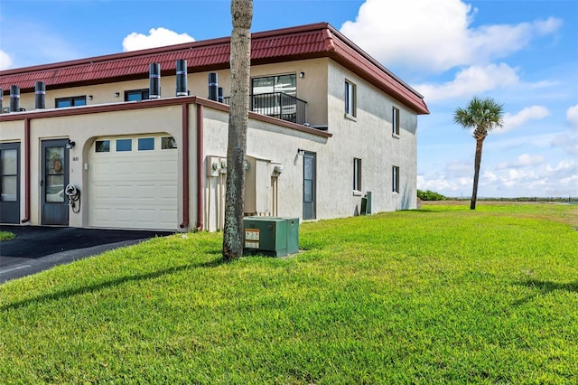 1601 N Ocean Shore Blvd, Flagler Beach, FL 32136 - view of side of property featuring a garage, a yard, stucco siding, and driveway