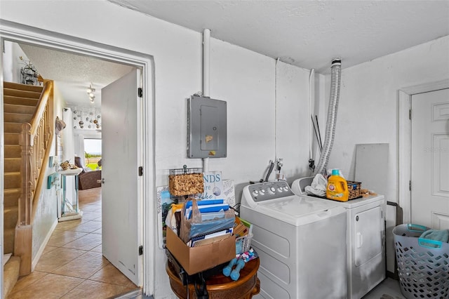 1601 N Ocean Shore Blvd, Flagler Beach, FL 32136 - laundry room featuring separate washer and dryer, a textured ceiling, electric panel, and light tile patterned flooring