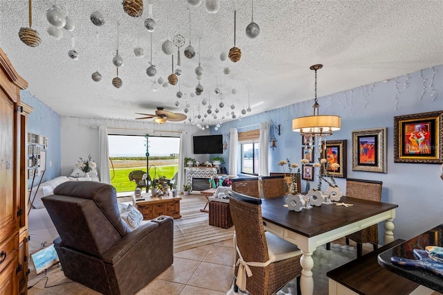 1601 N Ocean Shore Blvd, Flagler Beach, FL 32136 - dining room featuring a textured ceiling, light tile patterned floors, a ceiling fan, and a fireplace