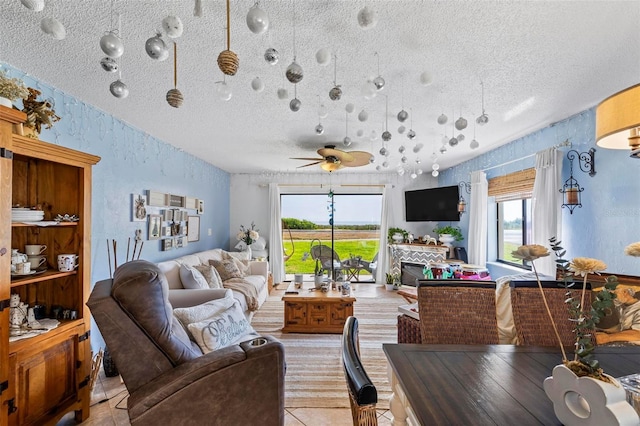 1601 N Ocean Shore Blvd, Flagler Beach, FL 32136 - living room with plenty of natural light, a textured ceiling, light tile patterned floors, a ceiling fan, and a textured wall
