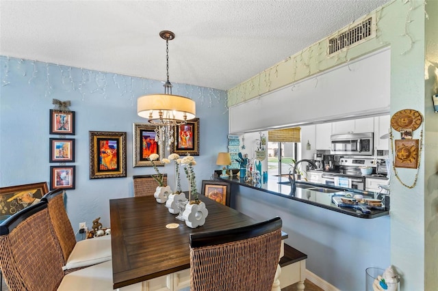 1601 N Ocean Shore Blvd, Flagler Beach, FL 32136 - dining room with a chandelier and a textured ceiling