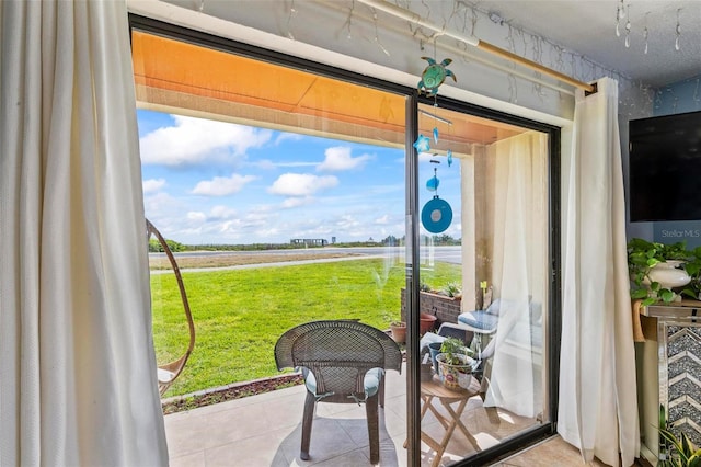 1601 N Ocean Shore Blvd, Flagler Beach, FL 32136 - doorway with tile patterned flooring and plenty of natural light