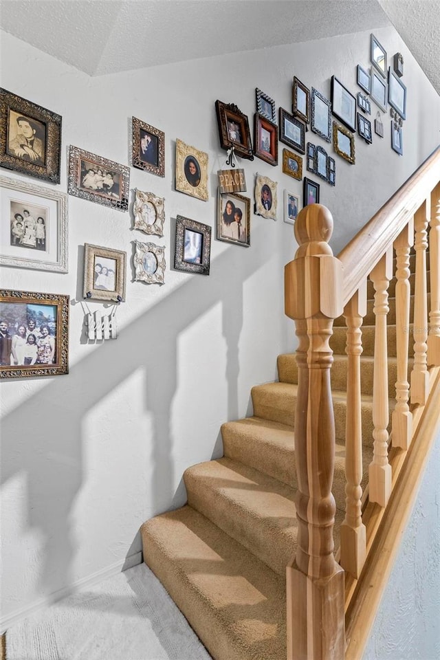 1601 N Ocean Shore Blvd, Flagler Beach, FL 32136 - stairs with a textured ceiling, vaulted ceiling, and carpet floors