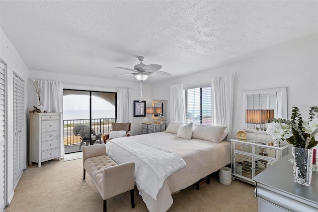 1601 N Ocean Shore Blvd, Flagler Beach, FL 32136 - bedroom featuring access to exterior, light colored carpet, a textured ceiling, and ceiling fan