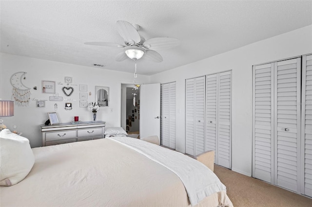 1601 N Ocean Shore Blvd, Flagler Beach, FL 32136 - carpeted bedroom with multiple closets, a textured ceiling, and ceiling fan