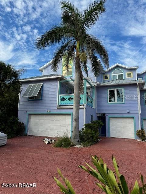 3000 Ocean Shore Blvd Unit 150, Ormond Beach, FL 32176 - view of front of house featuring an attached garage and decorative driveway