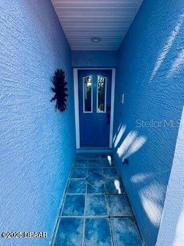 3000 Ocean Shore Blvd Unit 150, Ormond Beach, FL 32176 - doorway to property with stucco siding