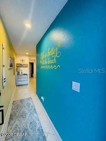 3000 Ocean Shore Blvd Unit 150, Ormond Beach, FL 32176 - corridor featuring baseboards, light tile patterned flooring, and recessed lighting