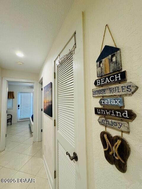3000 Ocean Shore Blvd Unit 150, Ormond Beach, FL 32176 - corridor with baseboards and light tile patterned floors