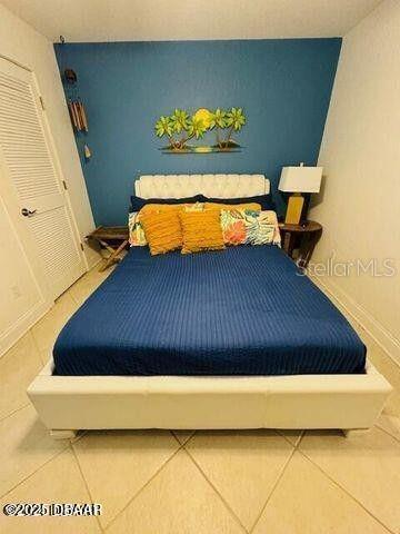 3000 Ocean Shore Blvd Unit 150, Ormond Beach, FL 32176 - bedroom featuring baseboards