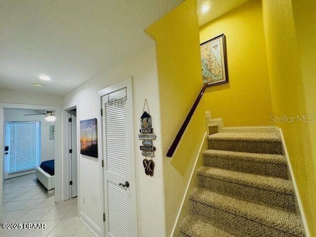 3000 Ocean Shore Blvd Unit 150, Ormond Beach, FL 32176 - staircase with baseboards, tile patterned flooring, recessed lighting, and a ceiling fan