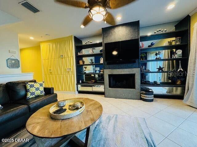 3000 Ocean Shore Blvd Unit 150, Ormond Beach, FL 32176 - tiled living area with ceiling fan, a fireplace, and visible vents