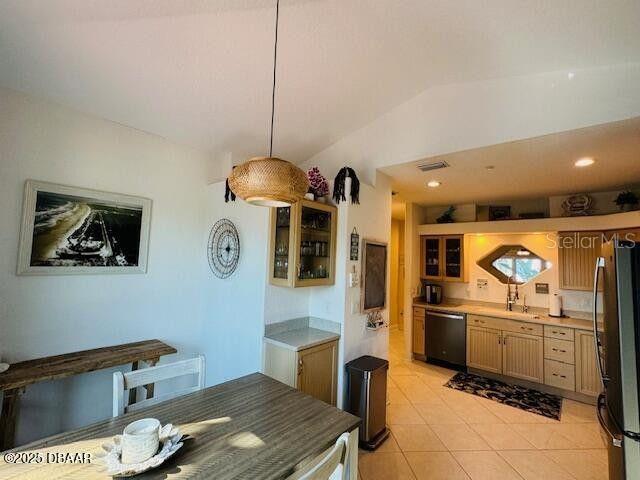 3000 Ocean Shore Blvd Unit 150, Ormond Beach, FL 32176 - kitchen with freestanding refrigerator, lofted ceiling, glass insert cabinets, dishwasher, and light tile patterned floors