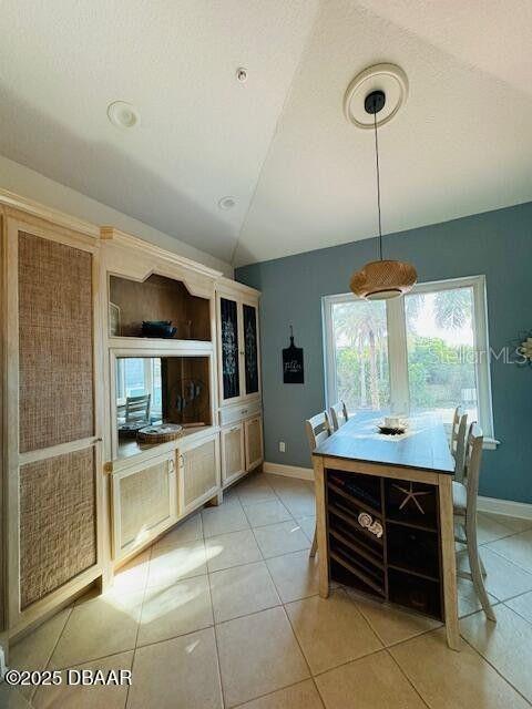 3000 Ocean Shore Blvd Unit 150, Ormond Beach, FL 32176 - dining room with baseboards and light tile patterned floors