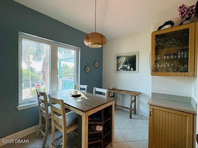 3000 Ocean Shore Blvd Unit 150, Ormond Beach, FL 32176 - dining space featuring light tile patterned floors and baseboards