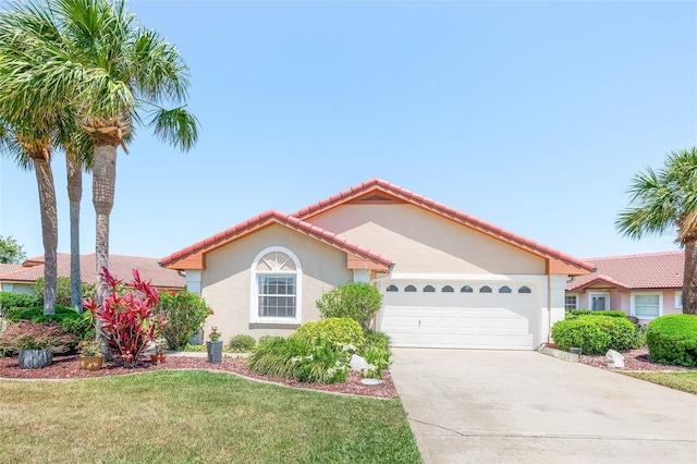 22 San Carlos Dr, Palm Coast, FL 32137 - mediterranean / spanish-style house with an attached garage, stucco siding, concrete driveway, a front yard, and a tiled roof