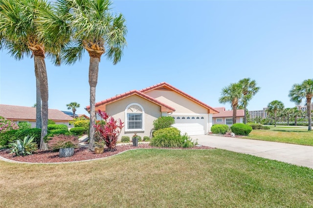 22 San Carlos Dr, Palm Coast, FL 32137 - mediterranean / spanish home with stucco siding, concrete driveway, a tiled roof, an attached garage, and a front lawn