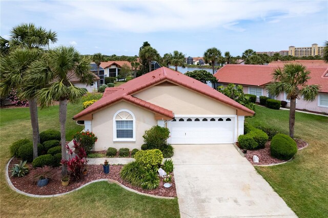 22 San Carlos Dr, Palm Coast, FL 32137 - mediterranean / spanish-style house featuring driveway, a front yard, stucco siding, an attached garage, and a tile roof