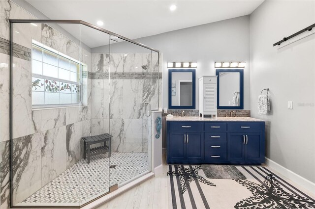 22 San Carlos Dr, Palm Coast, FL 32137 - full bathroom featuring a marble finish shower, double vanity, baseboards, recessed lighting, and wood finished floors