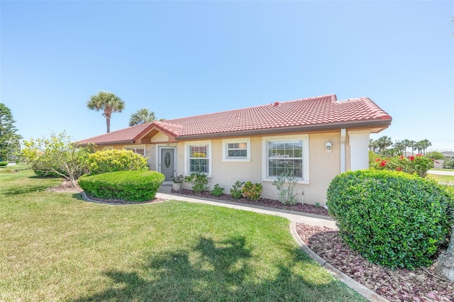 22 San Carlos Dr, Palm Coast, FL 32137 - ranch-style home with a tiled roof, stucco siding, and a front yard