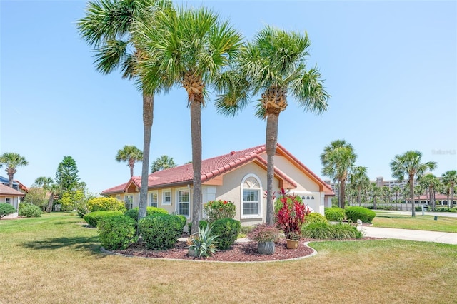 22 San Carlos Dr, Palm Coast, FL 32137 - view of side of property with an attached garage, a lawn, a tile roof, driveway, and stucco siding