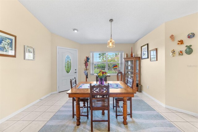 22 San Carlos Dr, Palm Coast, FL 32137 - dining room featuring light tile patterned floors, a textured ceiling, and baseboards