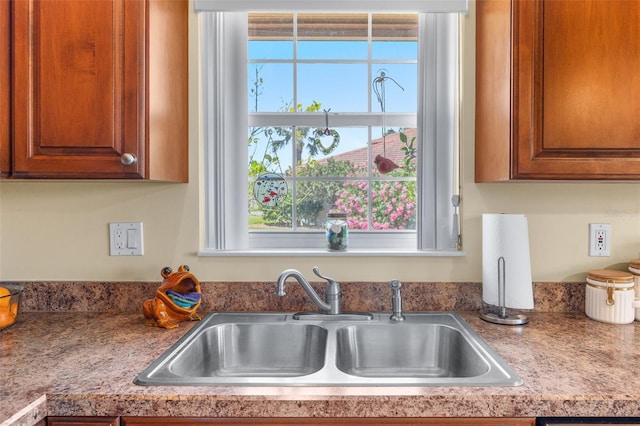 22 San Carlos Dr, Palm Coast, FL 32137 - kitchen featuring a sink and brown cabinetry