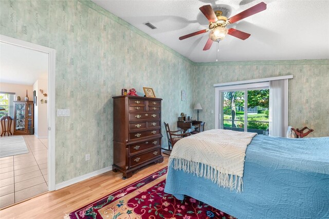 22 San Carlos Dr, Palm Coast, FL 32137 - bedroom with wood finished floors, baseboards, ceiling fan, and access to outside