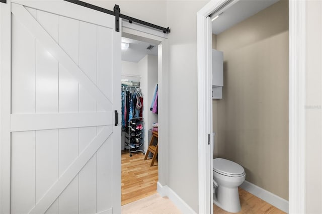 22 San Carlos Dr, Palm Coast, FL 32137 - bathroom with wood finished floors, baseboards, and toilet