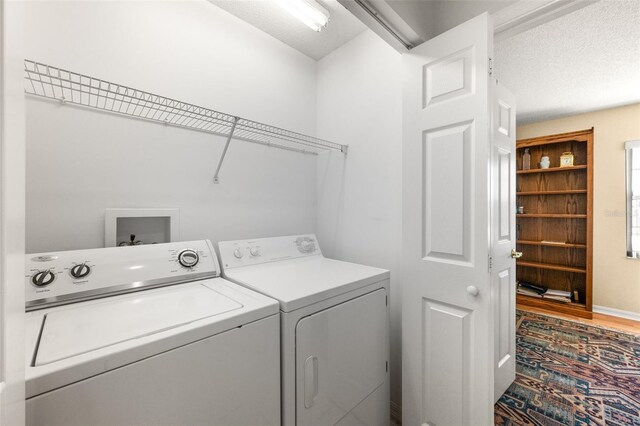 22 San Carlos Dr, Palm Coast, FL 32137 - laundry area with washer and dryer, a textured ceiling, and wood finished floors