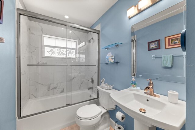 22 San Carlos Dr, Palm Coast, FL 32137 - bathroom featuring toilet, enclosed tub / shower combo, and a sink