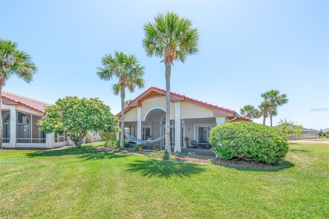 22 San Carlos Dr, Palm Coast, FL 32137 - rear view of house with a yard, a tile roof, and stucco siding
