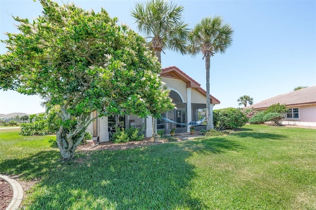 22 San Carlos Dr, Palm Coast, FL 32137 - view of grassy yard with a sunroom