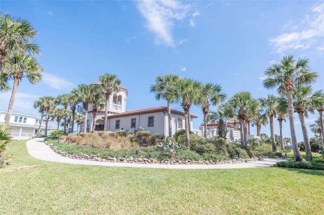 22 San Carlos Dr, Palm Coast, FL 32137 - view of property exterior featuring a yard and stucco siding
