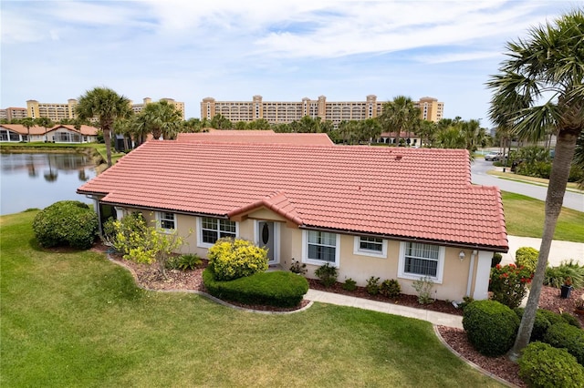22 San Carlos Dr, Palm Coast, FL 32137 - single story home with a tile roof, stucco siding, a front yard, and a water view