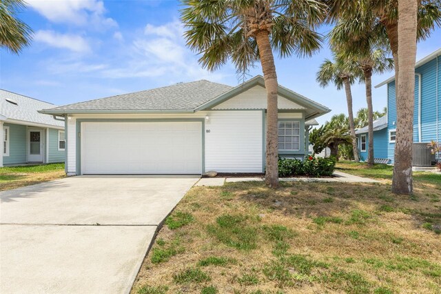 50 Nantucket Dr, Palm Coast, FL 32137 - view of front of home with an attached garage, concrete driveway, central AC, and a front yard