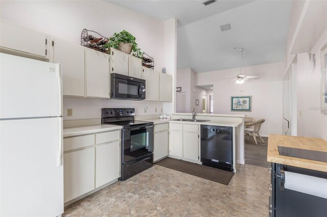 50 Nantucket Dr, Palm Coast, FL 32137 - kitchen featuring black appliances, a sink, a peninsula, light countertops, and high vaulted ceiling