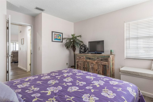 50 Nantucket Dr, Palm Coast, FL 32137 - bedroom with wood finished floors, baseboards, and a textured ceiling