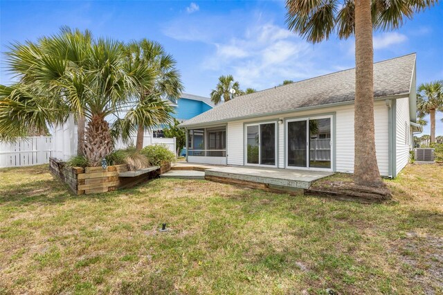 50 Nantucket Dr, Palm Coast, FL 32137 - back of property featuring central air condition unit, a sunroom, roof with shingles, and a patio
