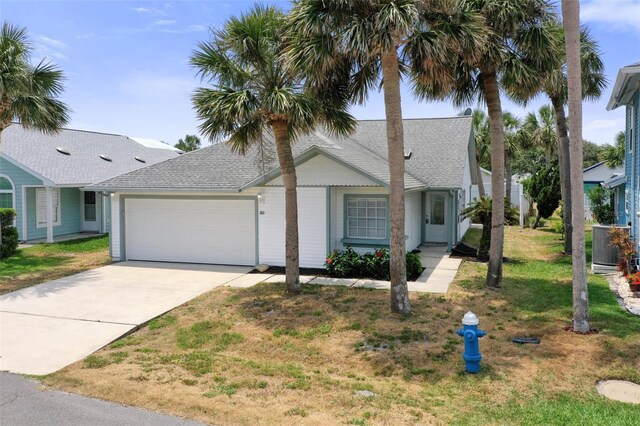 50 Nantucket Dr, Palm Coast, FL 32137 - view of front of property with an attached garage, a shingled roof, a front lawn, and driveway