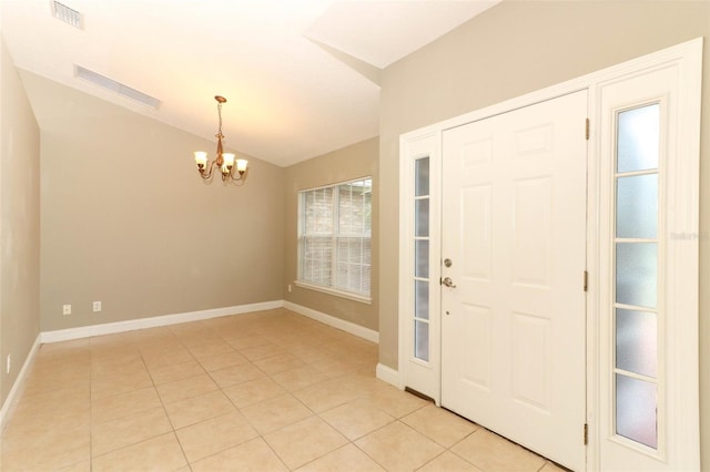 foyer entrance featuring lofted ceiling, baseboards, an inviting chandelier, visible vents, and light tile patterned flooring