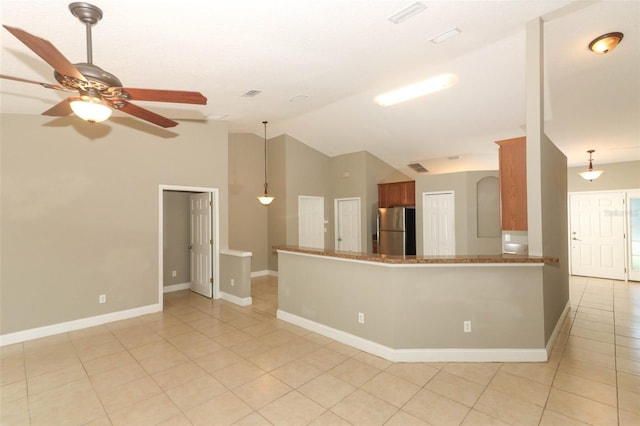 interior space featuring vaulted ceiling, ceiling fan, light tile patterned flooring, and baseboards