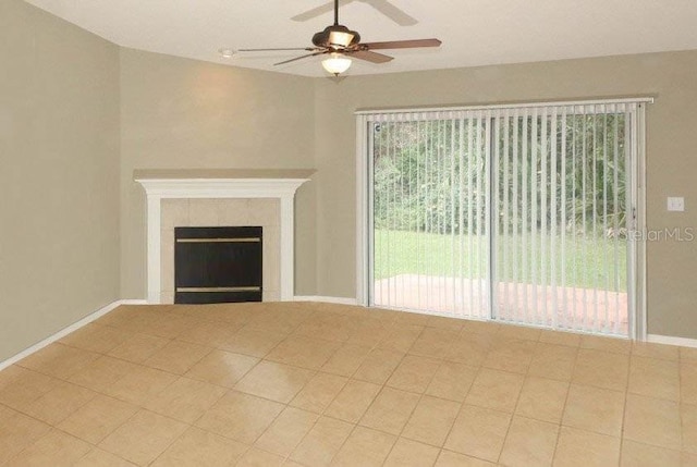 unfurnished living room featuring a fireplace, baseboards, and a ceiling fan