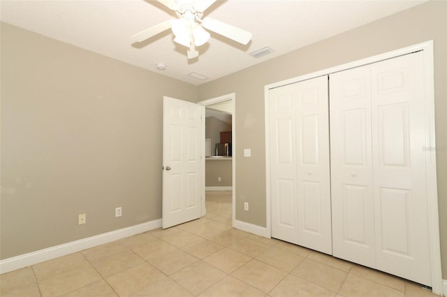 unfurnished bedroom with a closet, visible vents, baseboards, and light tile patterned flooring