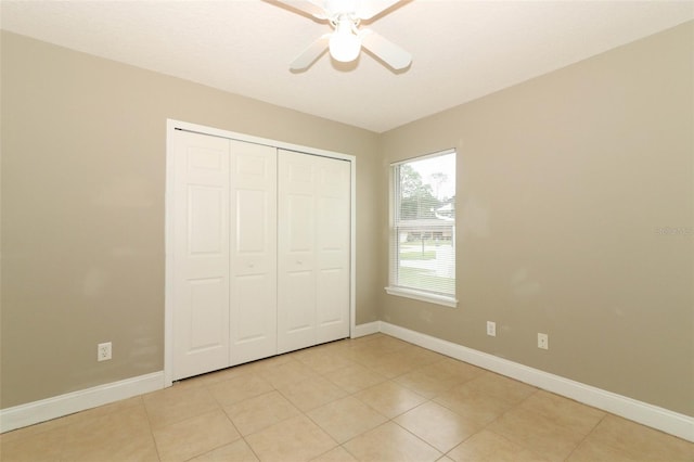 unfurnished bedroom with baseboards, a closet, and light tile patterned floors