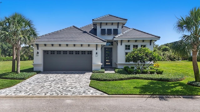 17 Kingfisher Ln, Palm Coast, FL 32137 - view of front of property with an attached garage, stucco siding, decorative driveway, a front yard, and a tile roof