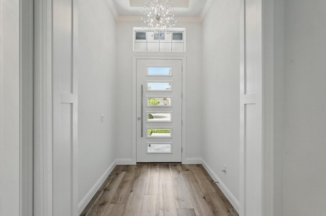 17 Kingfisher Ln, Palm Coast, FL 32137 - foyer entrance featuring a chandelier, crown molding, wood finished floors, and baseboards