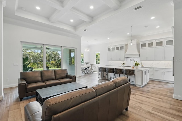 17 Kingfisher Ln, Palm Coast, FL 32137 - living area featuring beamed ceiling, recessed lighting, light wood-type flooring, coffered ceiling, and baseboards