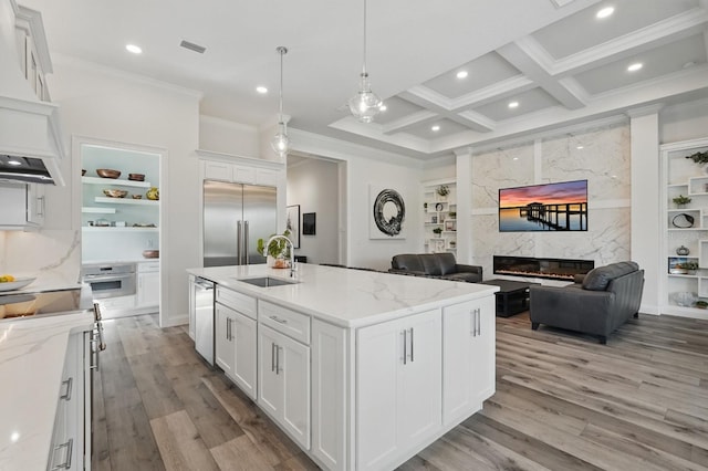17 Kingfisher Ln, Palm Coast, FL 32137 - kitchen with a sink, stainless steel appliances, ornamental molding, a fireplace, and wood finished floors