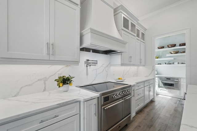 17 Kingfisher Ln, Palm Coast, FL 32137 - kitchen with appliances with stainless steel finishes, premium range hood, ornamental molding, backsplash, and white cabinets